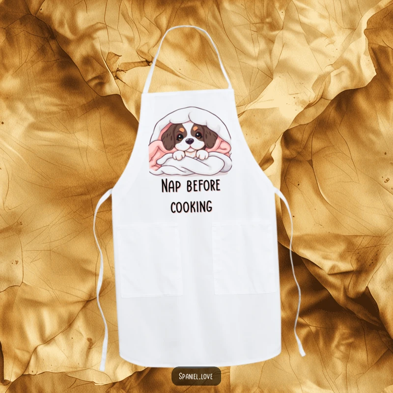 Funny apron with a spaniel puppy peeking from soft blankets, perfect for kitchen fun and dog lovers.