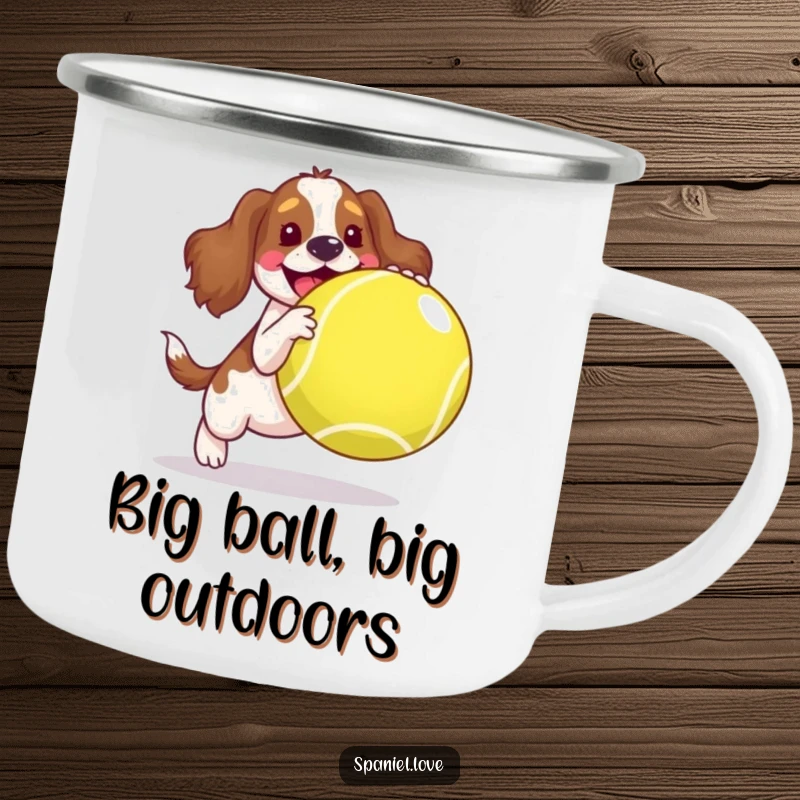 Funny spaniel camping mug, a joyful dog playing with an oversized tennis ball in a rustic setting, durable and humorous.
