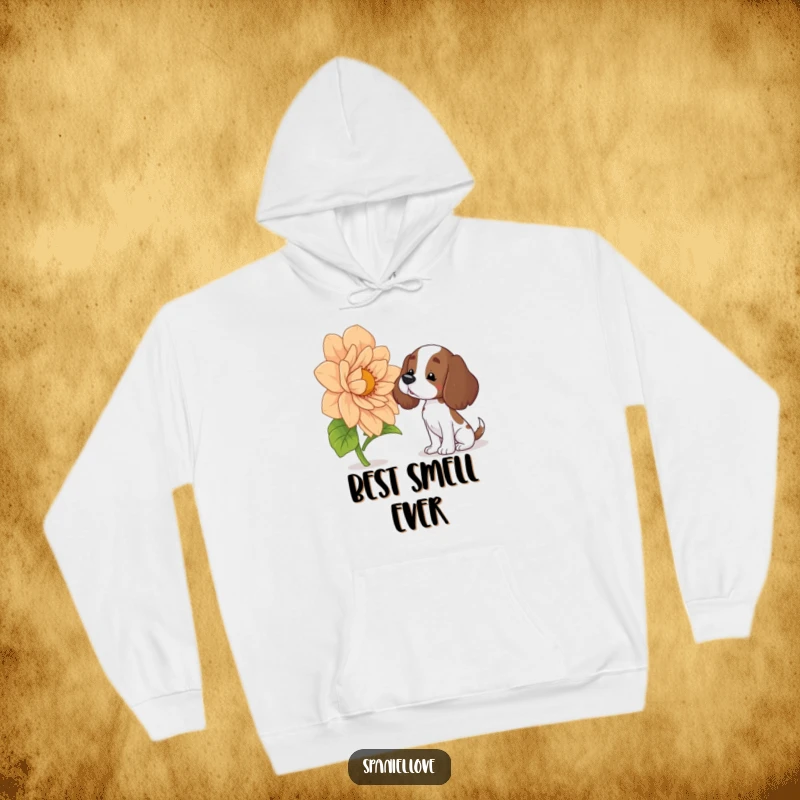 Funny spaniel hoodie showing a curious dog with a head tilt, sniffing an enormous, blooming flower, radiating warmth and humor.