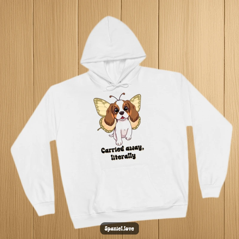Funny spaniel hoodie showing a surprised dog being carried by a big, friendly butterfly, offering cozy comfort and whimsical charm.