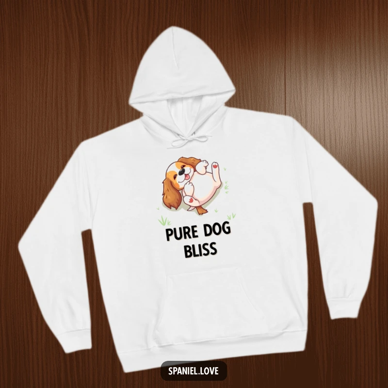 Funny spaniel rolling on its back in grass on a hoodie, perfect for cozy moments filled with canine humor.