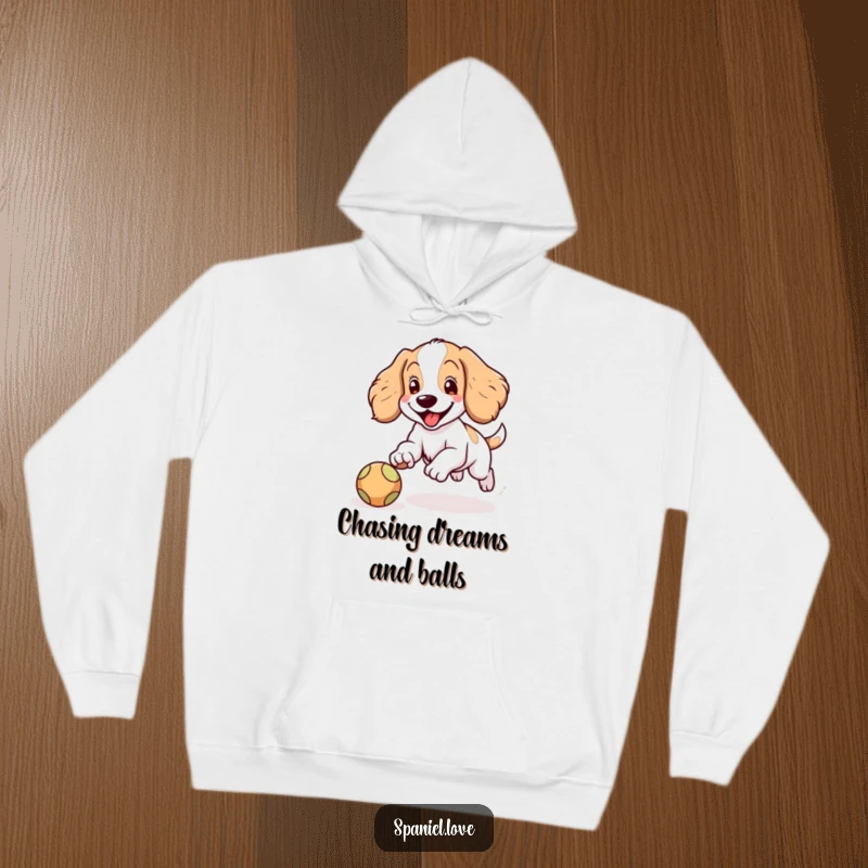 Funny Spaniel hoodie showcasing a happy Spaniel character with floppy ears joyfully chasing a bouncing ball, radiating warmth and playfulness.