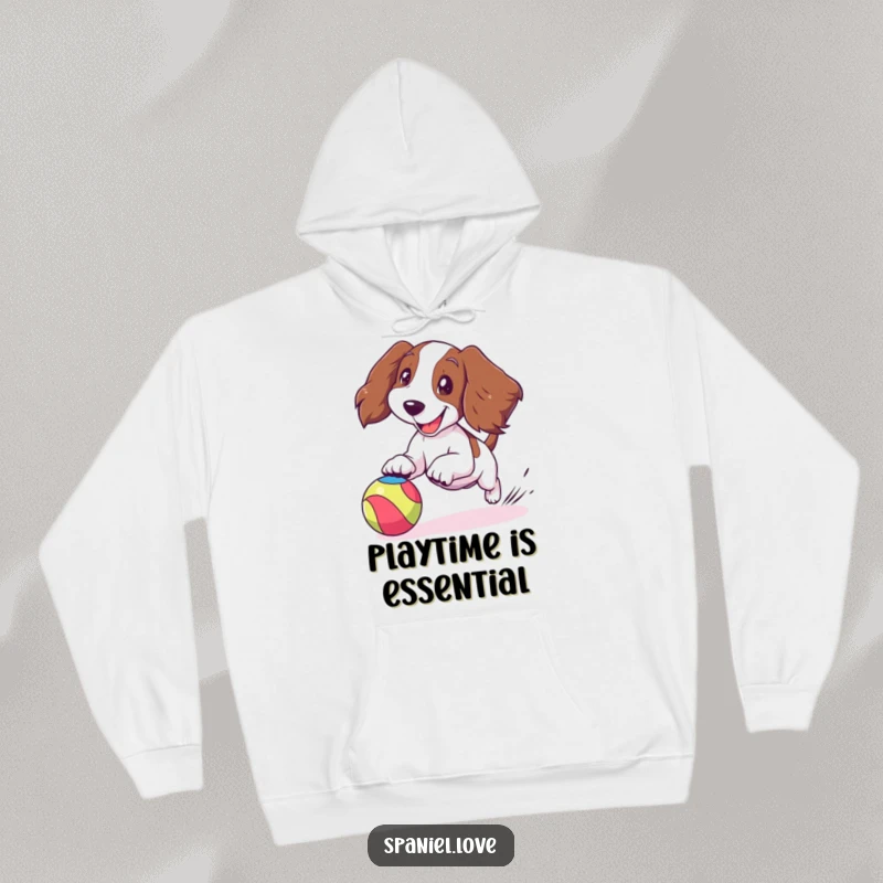 Funny spaniel hoodie featuring a cartoon spaniel joyfully chasing a bouncing colorful ball, ears flapping dynamically, cozy and fun.