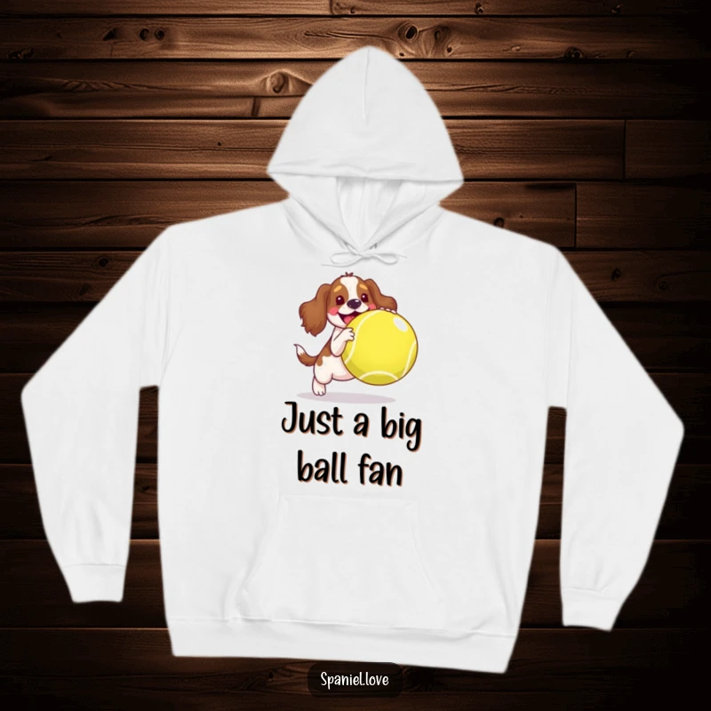 Funny spaniel hoodie, a joyful dog bouncing a massive tennis ball, symbolizing pure happiness and playful energy.