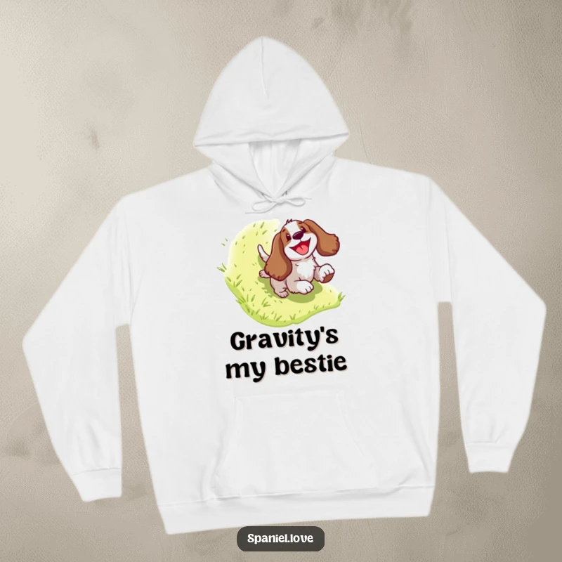 Funny Spaniel Hoodie: Comical dog character enjoying a thrilling slide down a grassy slope, capturing a moment of pure delight.