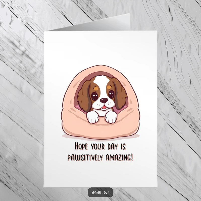 Funny free printable birthday card with a spaniel peeking from behind a dog bed, looking excited for cake.
