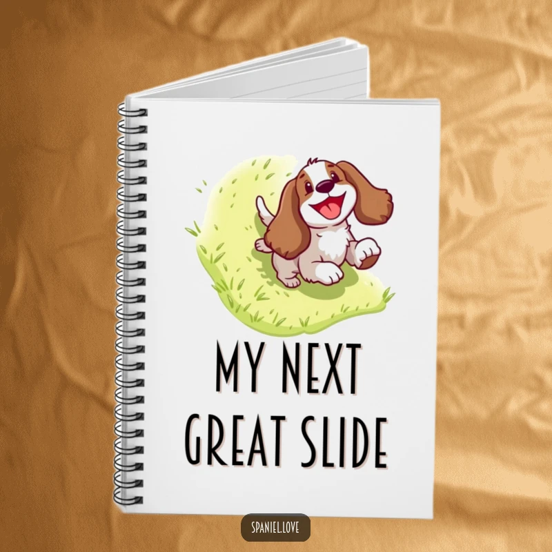 Funny Spaniel Notebook: A happy dog character mid-slide down a grassy hill, perfect for notes and creative bursts.