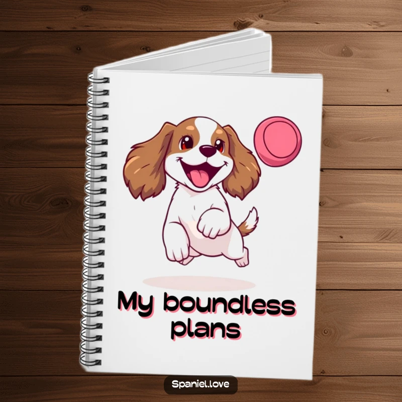 Funny notebook cover showing a happy spaniel mid-leap for a frisbee, tongue lolling, ideal for capturing energetic ideas.