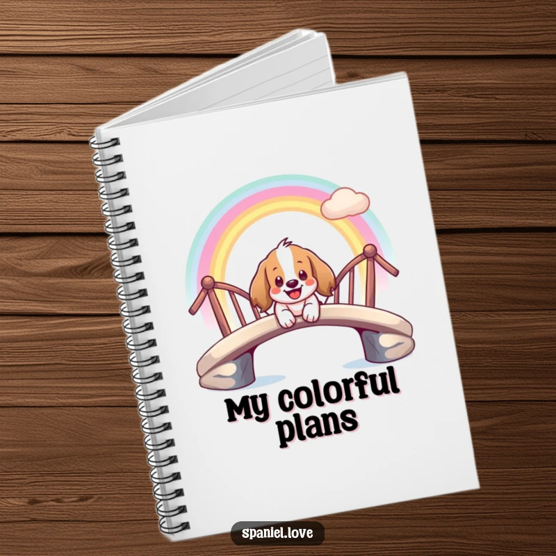 Funny notebook illustrating a giddy spaniel character smiling while sliding down a rainbow bridge.