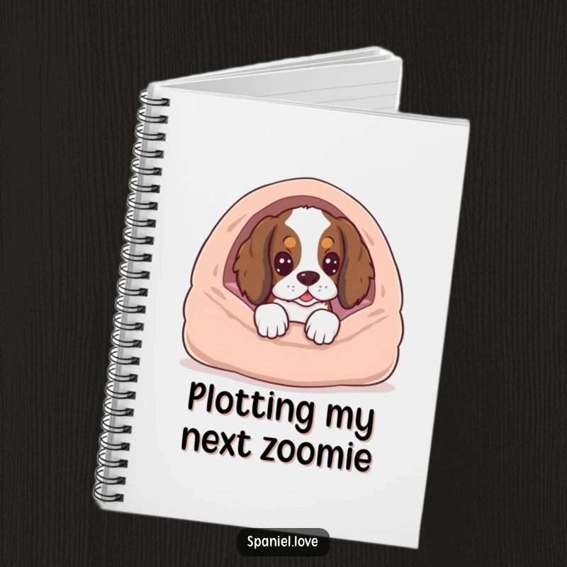 Funny spaniel dog peeking from behind a dog bed, notebook cover, symbolizing anticipation and ideas.