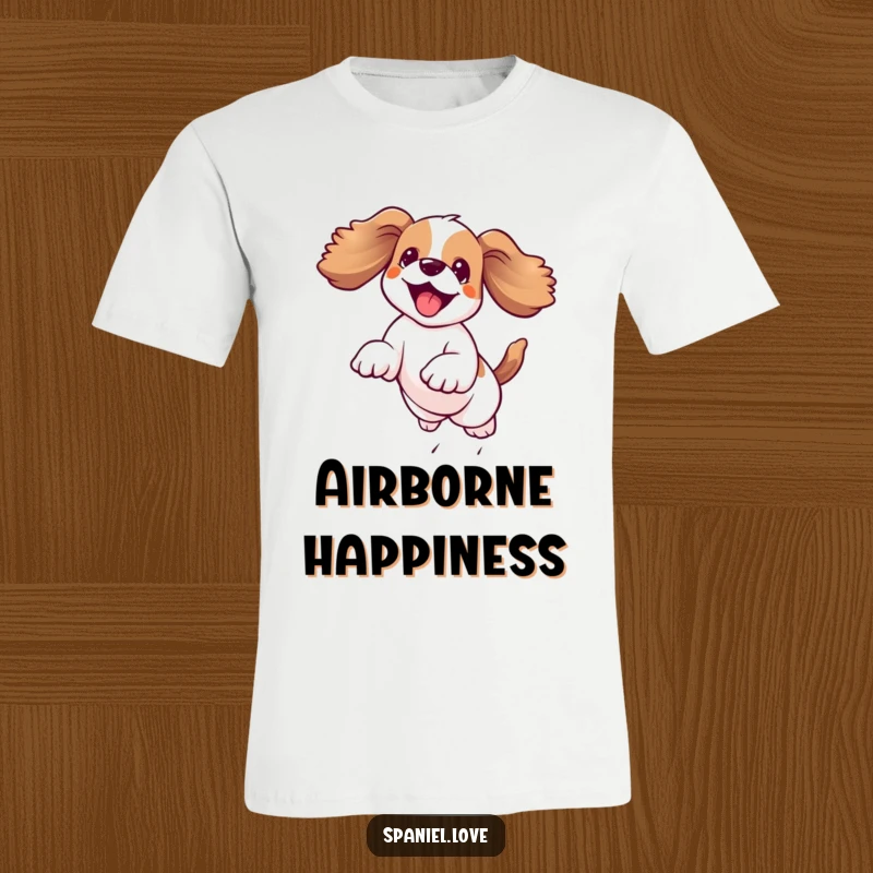 Funny kawaii spaniel leaping joyfully mid-air with its floppy ears dramatically flying, printed on a humorous t-shirt.