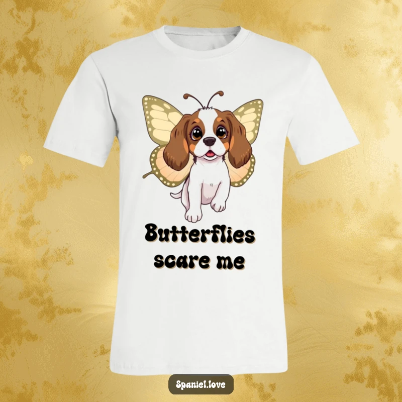 Funny spaniel t-shirt featuring a wide-eyed, surprised dog being gently lifted and carried by a large, friendly butterfly, a scene of wonder.