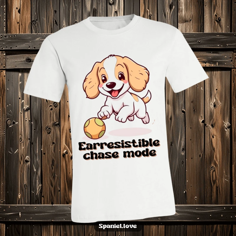 Funny Spaniel t-shirt depicting a happy Spaniel character with floppy ears joyfully chasing a bouncing ball, embodying pure canine excitement.