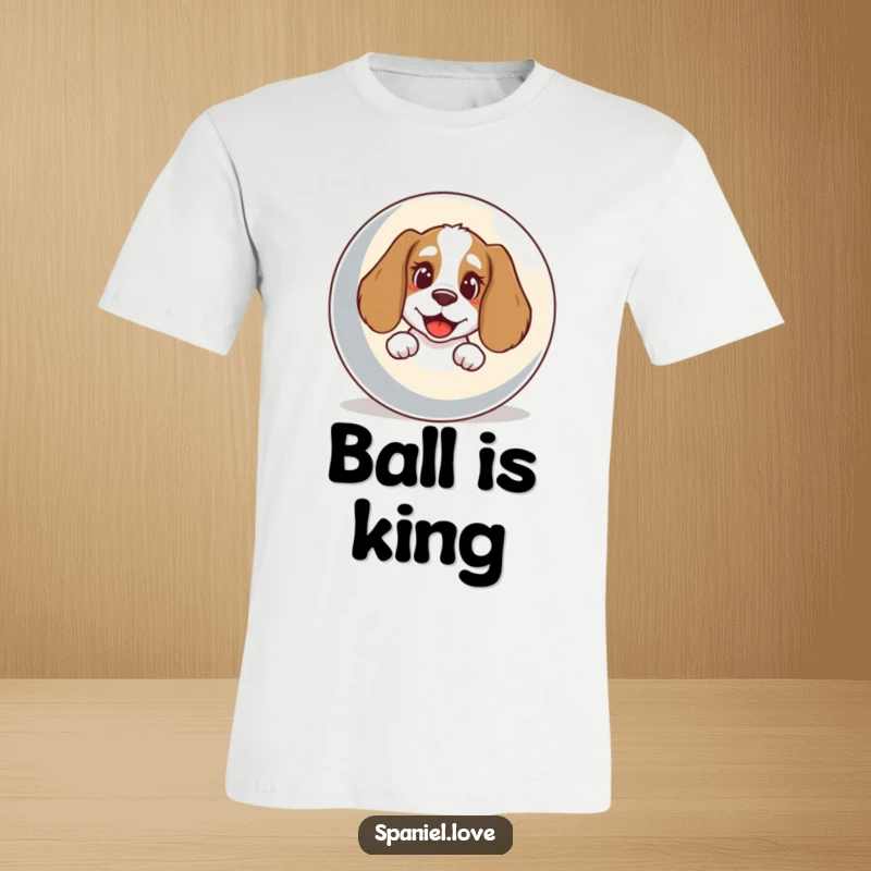 Funny Spaniel T-Shirt: A spaniel with a joyous bark peeks playfully from behind a massive, colorful ball.
