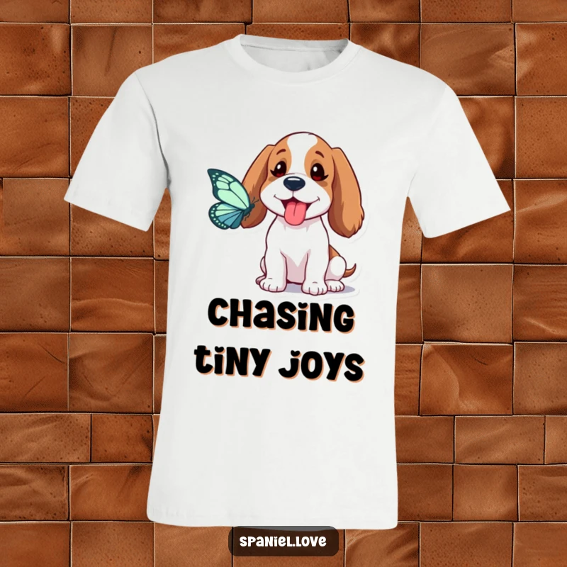 Funny Spaniel T-Shirt: A spaniel playfully sticks its tongue out, hilariously attempting to catch a butterfly in a whimsical scene.