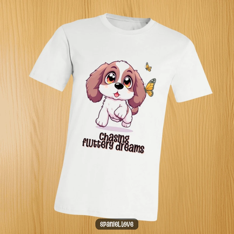 Funny Spaniel t-shirt depicting a Spaniel with oversized, sparkling eyes joyfully leaping towards a butterfly, radiating pure delight.