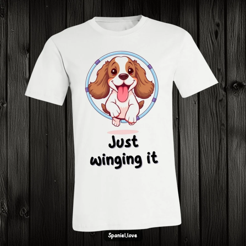 Funny spaniel t-shirt featuring an excited dog mid-air, tongue out, successfully jumping through a whimsical hula hoop with pure delight.