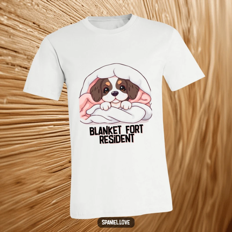 Funny t-shirt depicting a spaniel puppy peeking from soft blankets, embodying pure cuteness and a playful spirit.