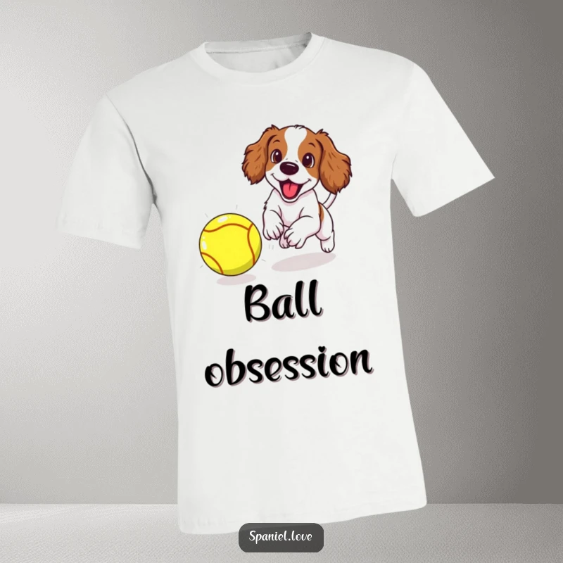 Funny spaniel puppy excitedly chasing a very large tennis ball with enthusiastic focus, printed on a humorous t-shirt.
