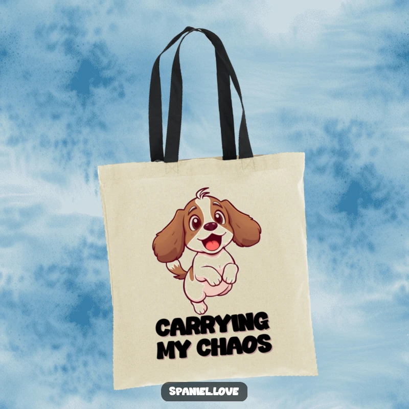 Funny tote bag featuring a surprised spaniel character leaping away from its own vigorously wagging tail.