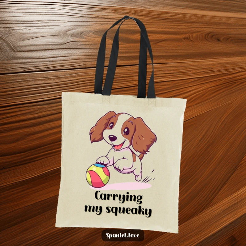 Funny spaniel tote bag with a cartoon spaniel joyfully chasing a bouncing colorful ball, ears flapping, a stylish and happy accessory.