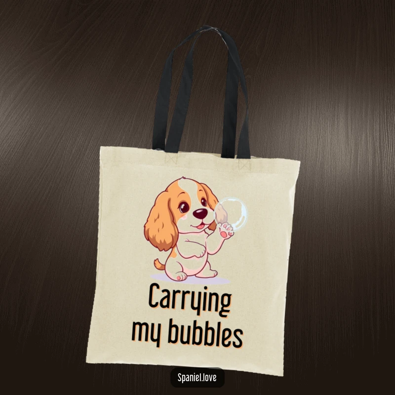 Funny Spaniel pup tote bag, hilariously focused on pawing a floating bubble, a practical and amusing accessory for dog lovers.