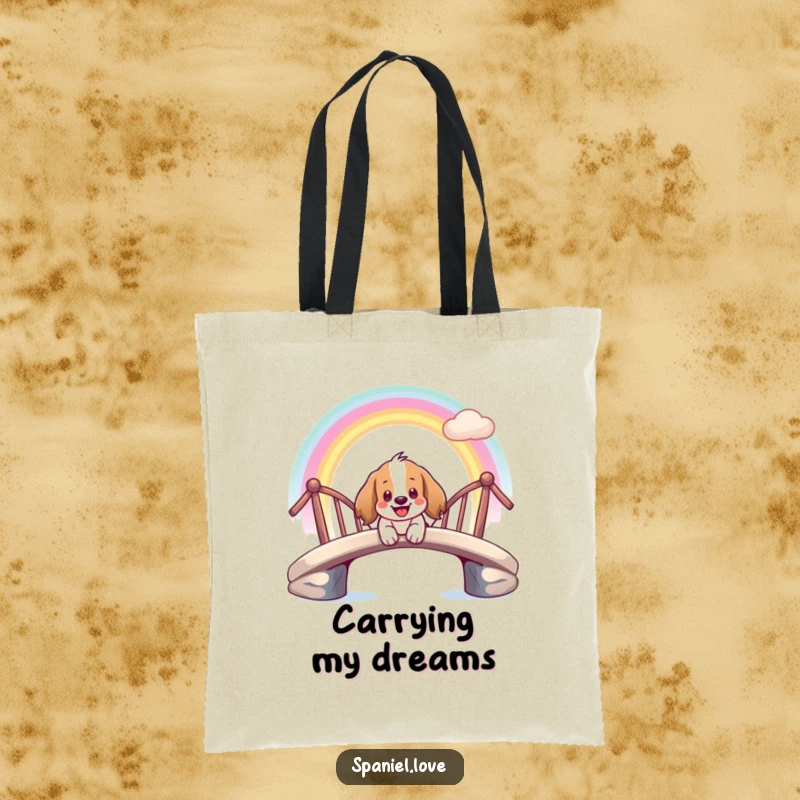 Funny tote bag featuring a giddy spaniel character smiling as it slides down a vibrant rainbow bridge.