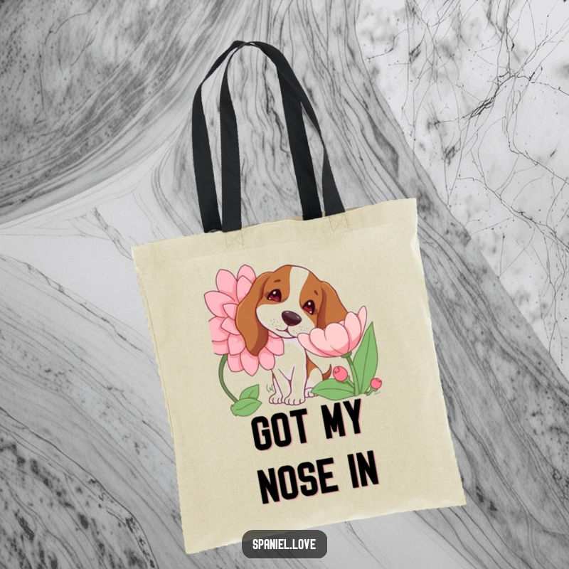 Funny tote bag depicting a spaniel dog with a tilted head curiously sniffing a giant, brightly colored blooming flower, embodying gentle exploration.